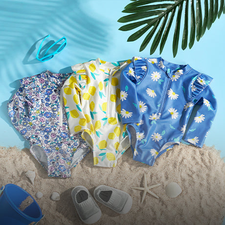 Three summery swimwear outfits laying on a beach scene with baby shoes and starfish around them.