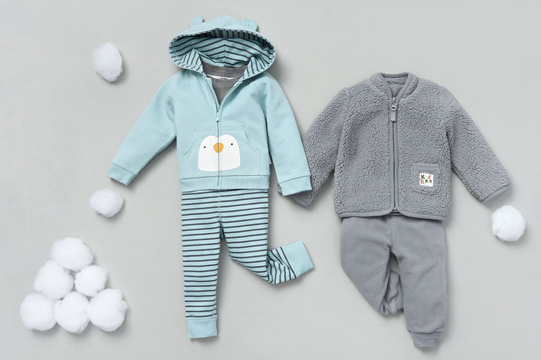 Two adorable baby outfits featuring a penguin design and snowball accents. Perfect for winter fun!
